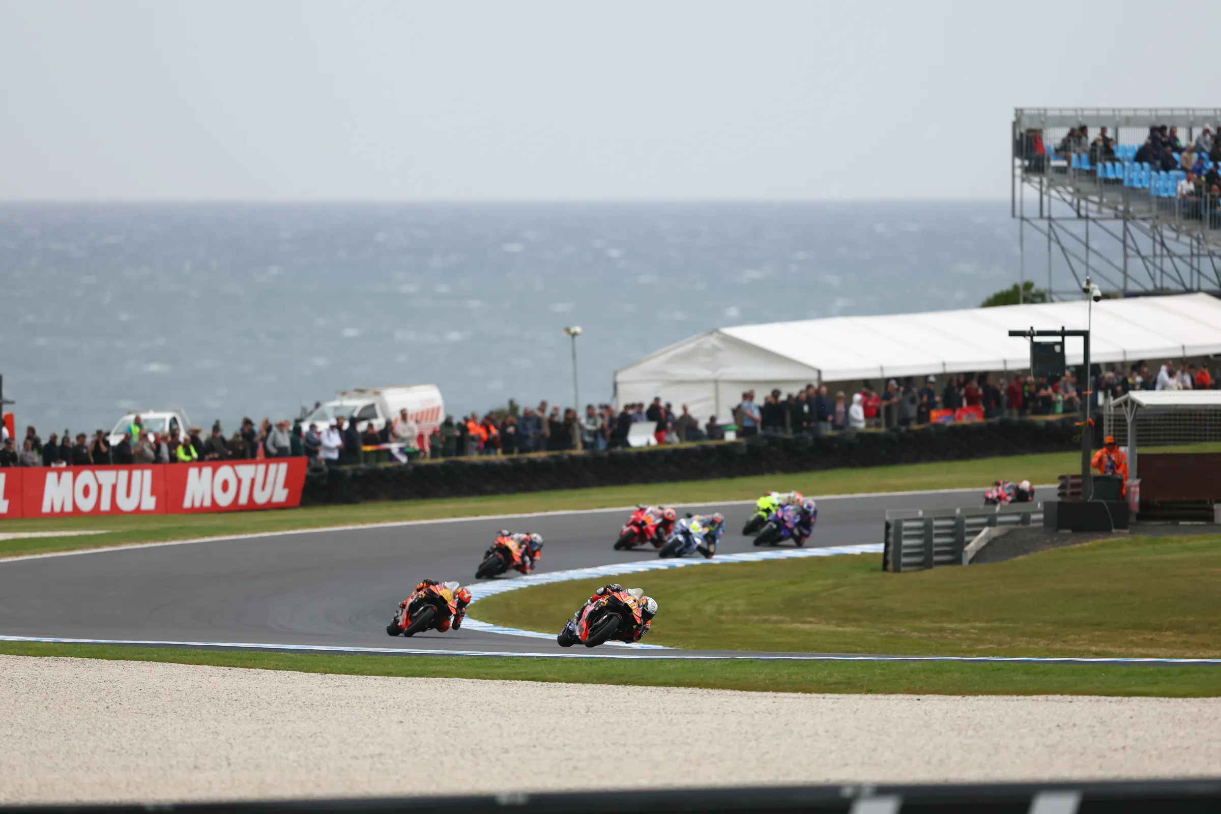 MotoGP riders racing past the ocean at Phillip Island